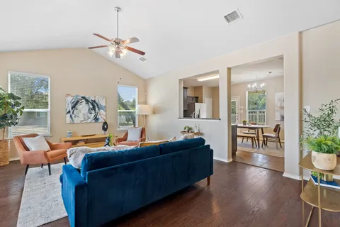 a living room with furniture a window and a chandelier