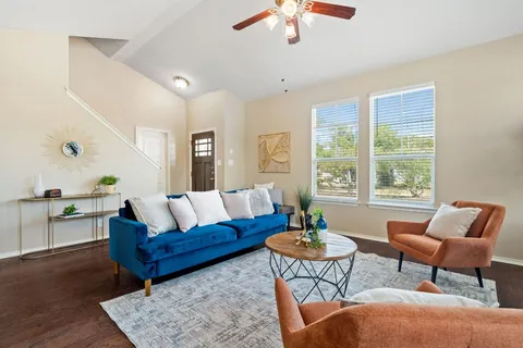 a living room with furniture and a large window