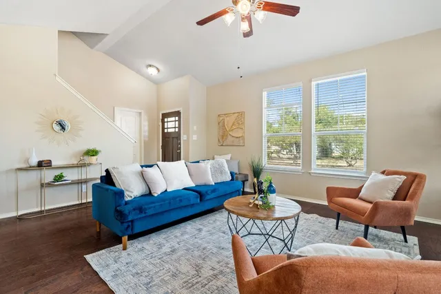 a living room with furniture and a large window