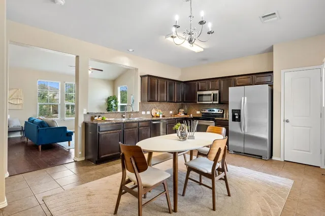 a view of a dining room with furniture and window