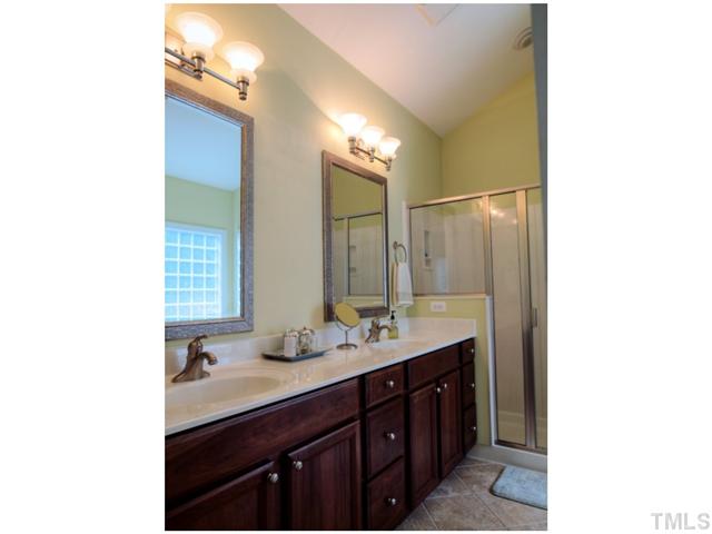2809 Cowley Road Cary, NC 27518 - Photo 13 of 25 Double Vanity, Tile Floor, Framed Mirrors, Separate Shower with bench seat.