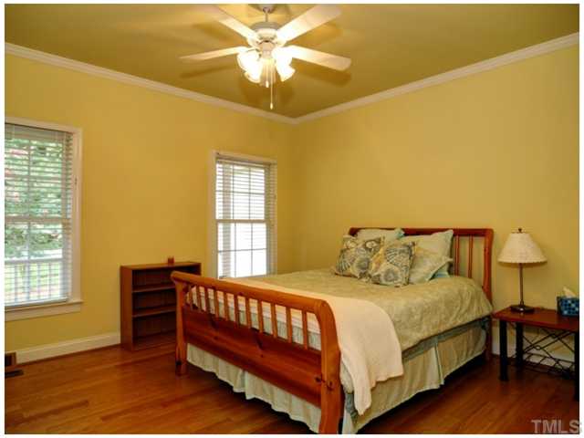 2809 Cowley Road Cary, NC 27518 - Photo 22 of 25 Generous First Floor bedroom with crown molding, ceiling fan, hardwood floors, nice closet