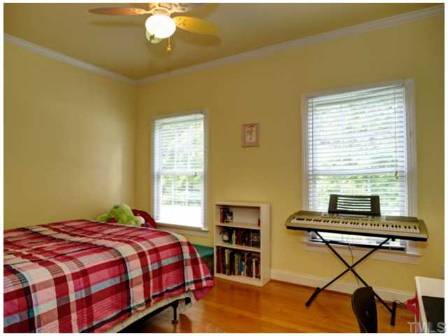 2809 Cowley Road Cary, NC 27518 - Photo 23 of 25 Another nice sized bedroom with crown molding, ceiling fan and hardwood floors, on the main level