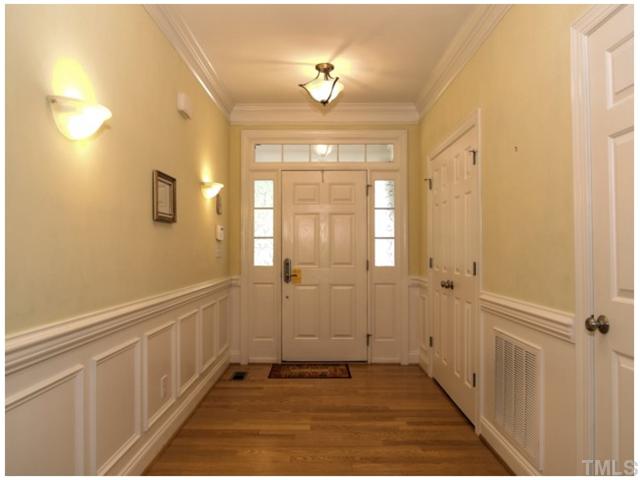 2809 Cowley Road Cary, NC 27518 - Photo 3 of 25 Gorgeous Foyer with Transom, Sidelights, Crown, Chair and Picture Frame Molding, pretty lighting, Harwood Floors, Large coat closet