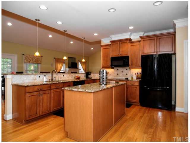 2809 Cowley Road Cary, NC 27518 - Photo 4 of 25 Huge Kitchen with Plenty of room for multiple chefs. Open to Dining Room, Family Room with a great long breakfast bar. Look at all that granite!