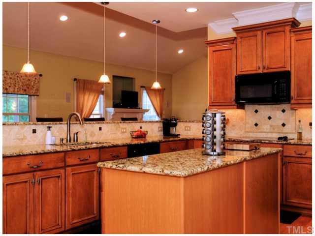 2809 Cowley Road Cary, NC 27518 - Photo 5 of 25 Cooks Kitchen with Island, Tons of Glazed Maple Cabinets, Tile Backsplash, Granite Counter tops.