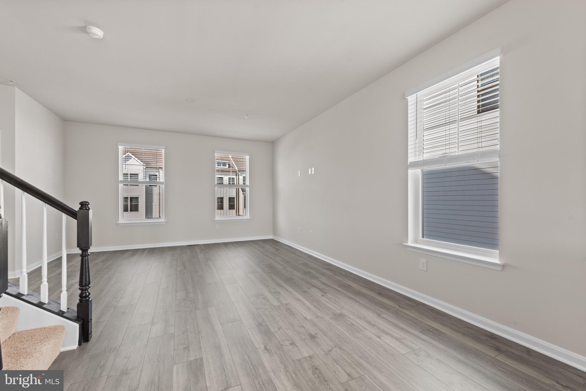 329 Ensemble Way Frederick, MD 21701 - Photo 15 of 40 a view of an empty room with wooden floor and a window