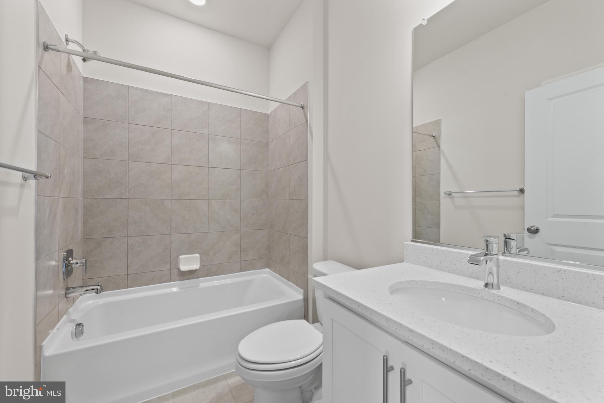 329 Ensemble Way Frederick, MD 21701 - Photo 27 of 40 a bathroom with a granite countertop toilet a sink and a bathtub