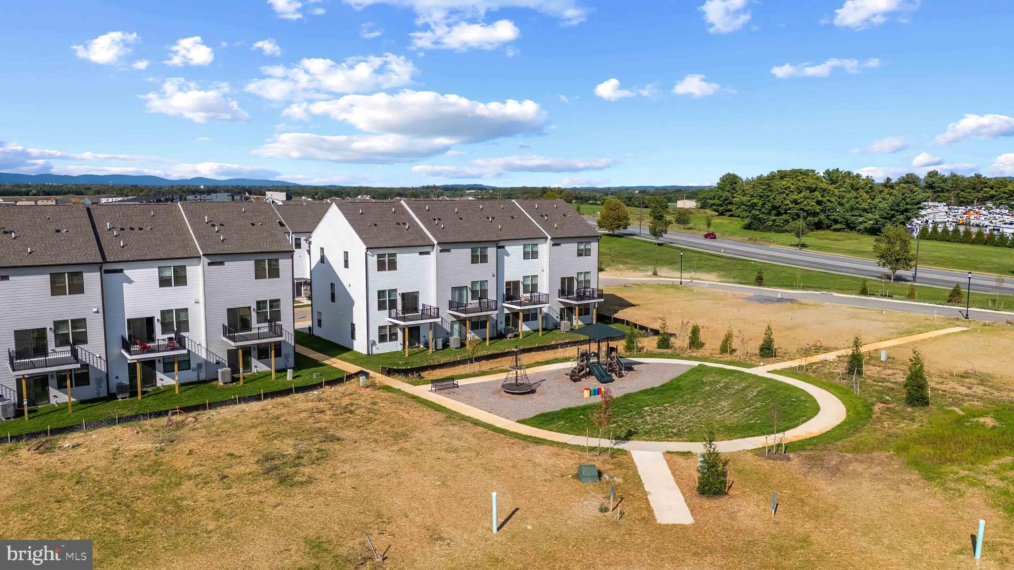 329 Ensemble Way Frederick, MD 21701 - Photo 39 of 40 a swimming pool with outdoor seating and yard
