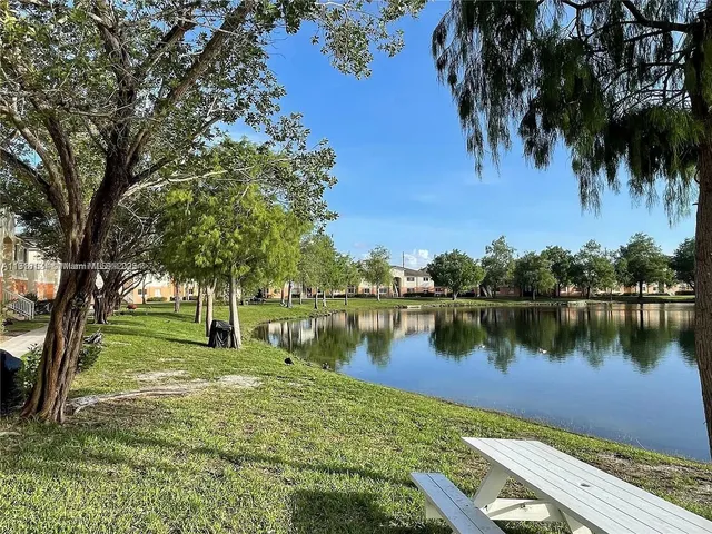 a view of a house with swimming pool and a yard