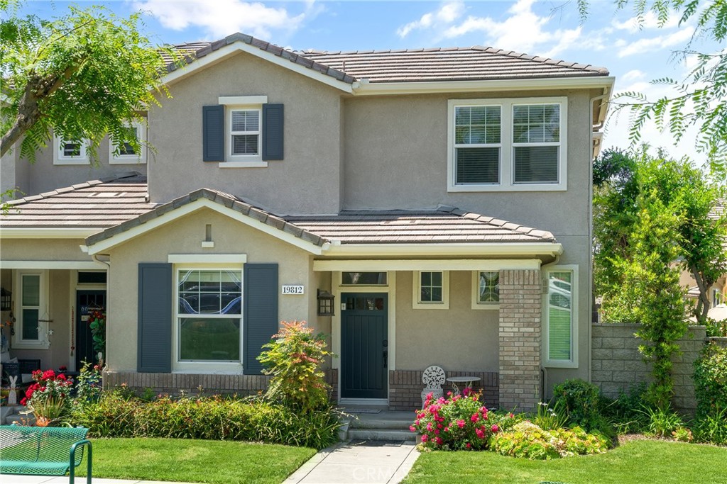 a front view of a house with garden