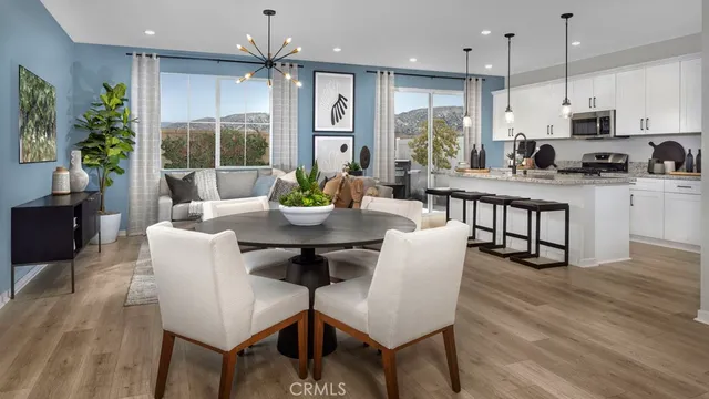 a living room with furniture a window and a dining table