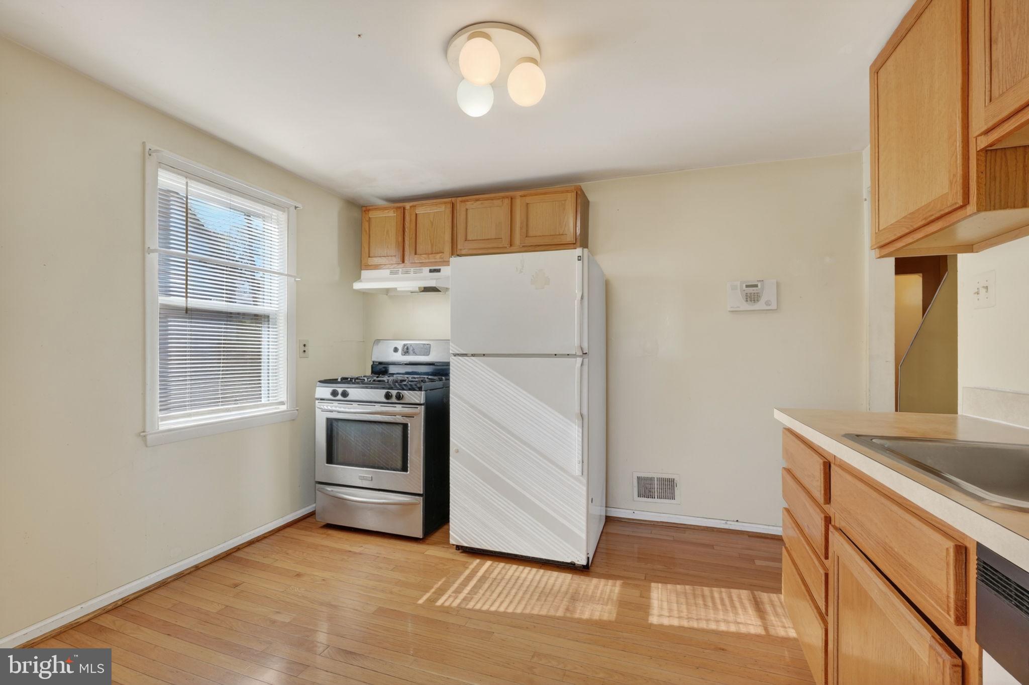 5441 Taussig Road Bladensburg, MD 20710 - Photo 11 of 37 a kitchen with a refrigerator and a sink