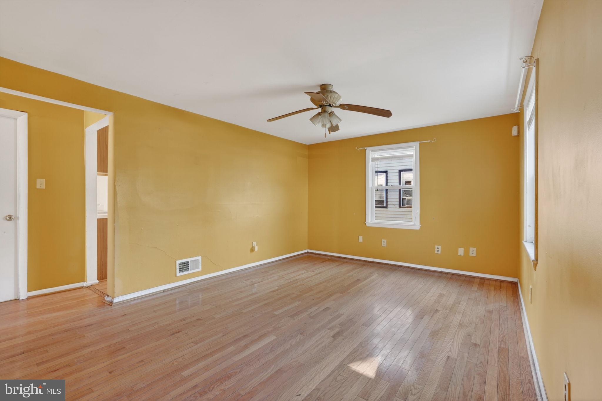 5441 Taussig Road Bladensburg, MD 20710 - Photo 5 of 37 a view of empty room with wooden floor and fan