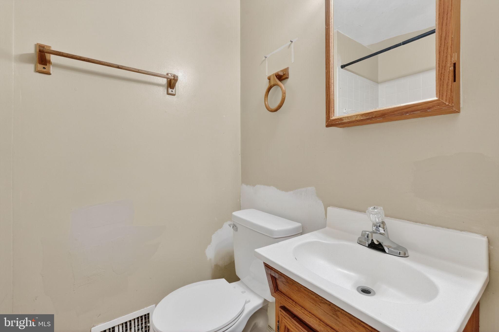 5441 Taussig Road Bladensburg, MD 20710 - Photo 8 of 37 a bathroom with a sink mirror and toilet