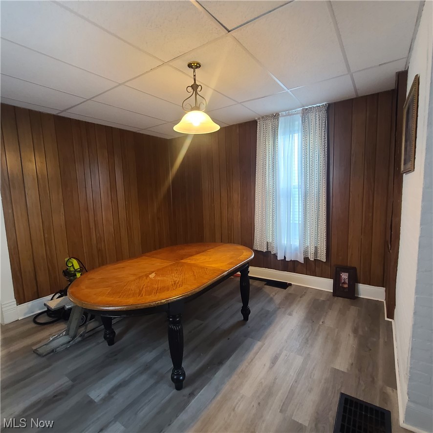 854 National Road Bridgeport, OH 43912 - Photo 12 of 27 Playroom with wooden walls, a drop ceiling, and laminate flooring