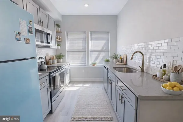 a kitchen with granite countertop a sink and a stove top oven