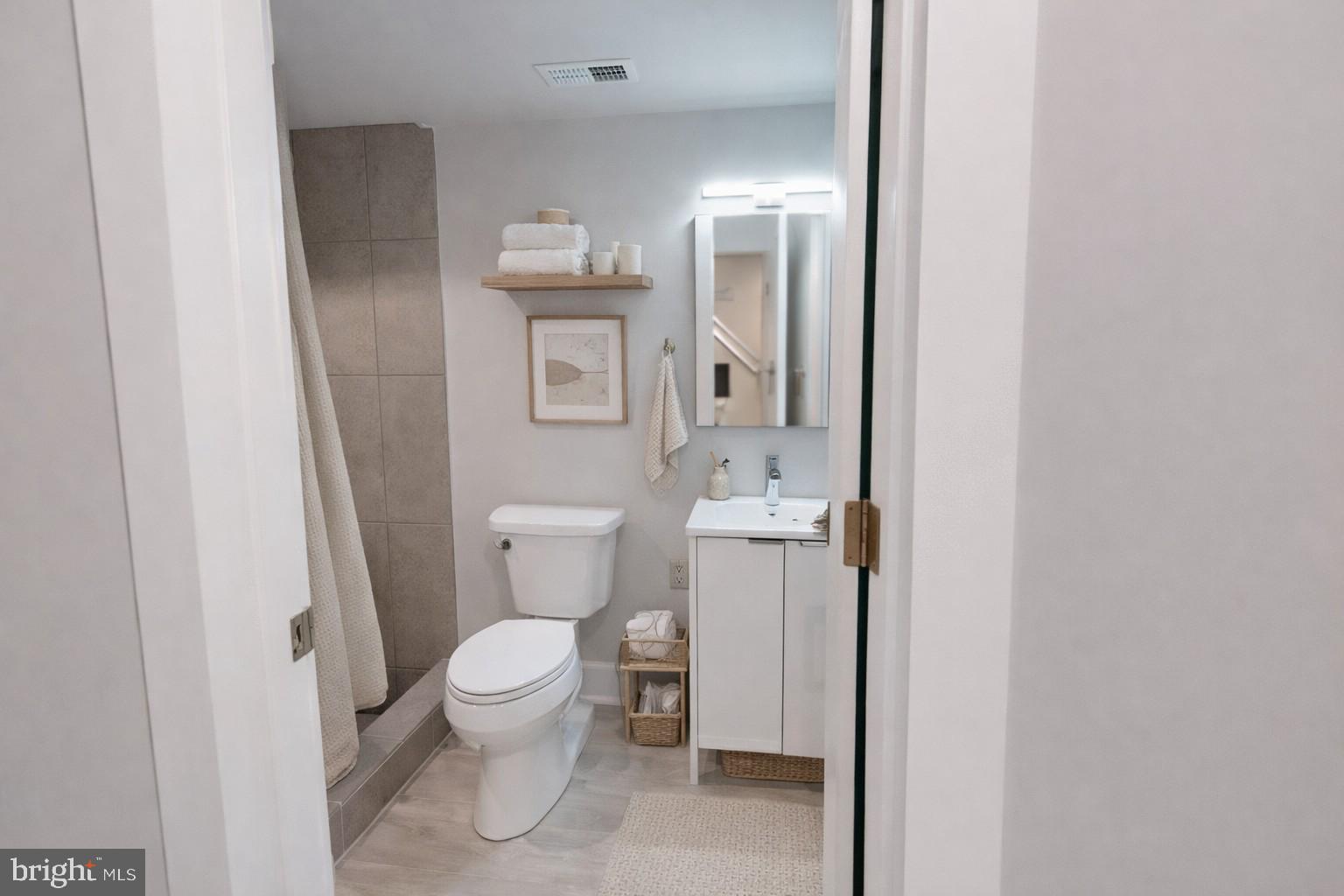 650 North 36th Street, Unit 1 Philadelphia, PA 19104 - Photo 8 of 15 a bathroom with a toilet sink and mirror