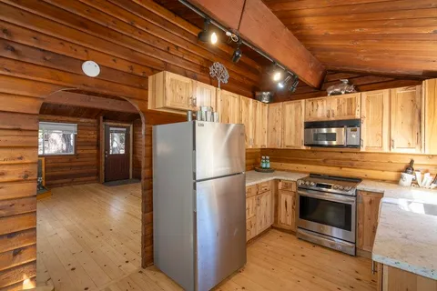 a kitchen with stainless steel appliances sink stove microwave and cabinets