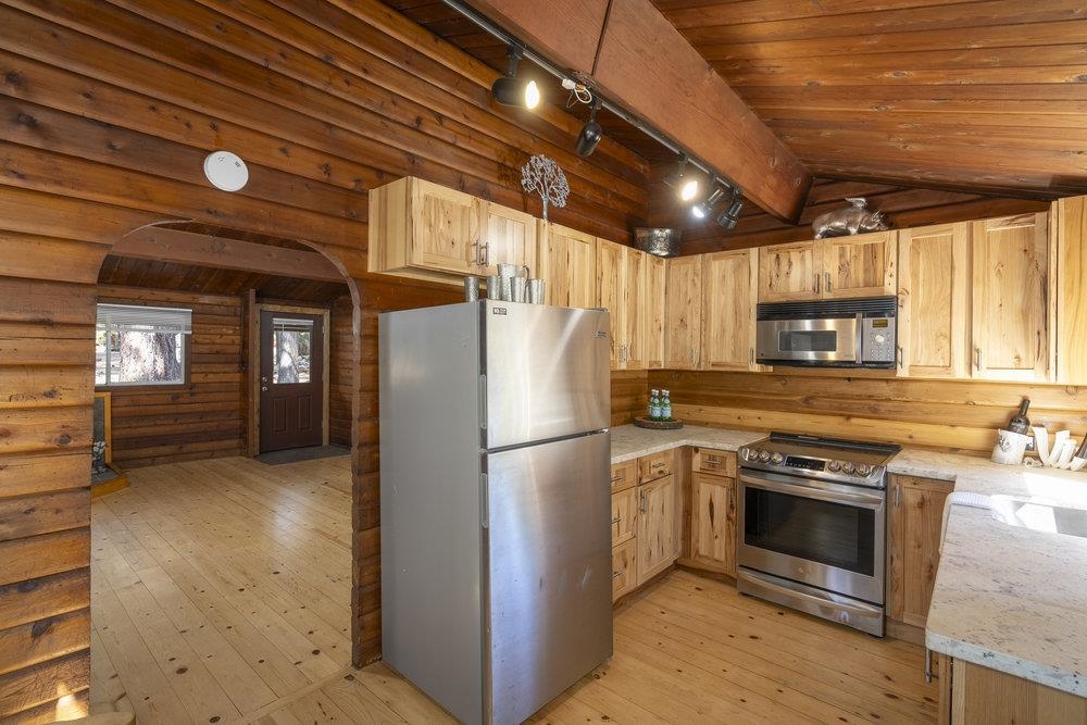 357 Wawasee Avenue Tahoe Vista, CA 96148 - Photo 12 of 28 a kitchen with a refrigerator and a stove top oven