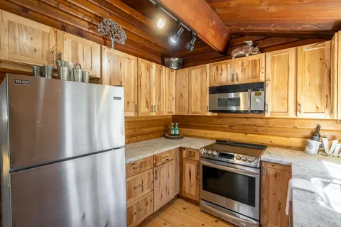 a kitchen with granite countertop a sink and a stove