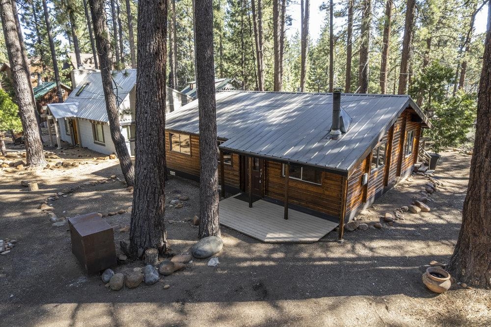 357 Wawasee Avenue Tahoe Vista, CA 96148 - Photo 4 of 28 a view of a wooden house with a yard