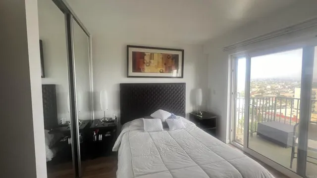 a bedroom with a bed and glass door