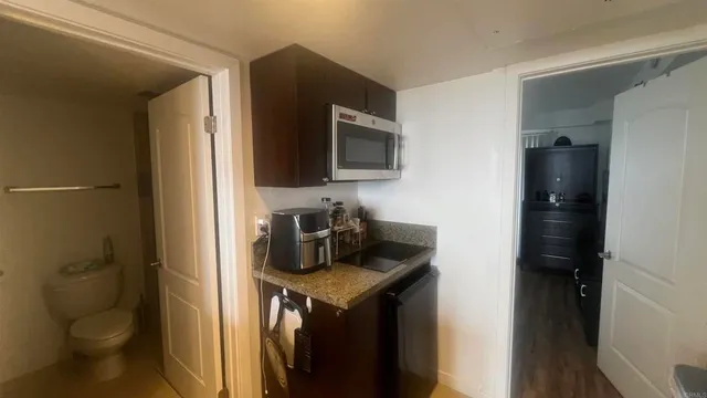 a kitchen with a sink and a stove top oven