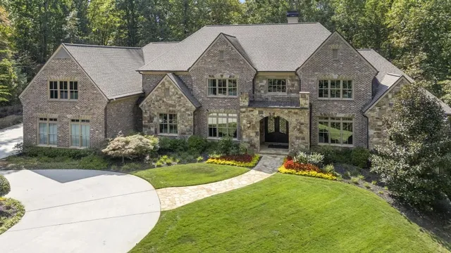 a front view of a house with a garden and plants