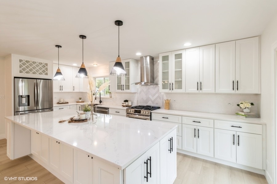 815 Downing Drive Schaumburg, IL 60169 - Photo 5 of 8 a kitchen with white cabinets and sink