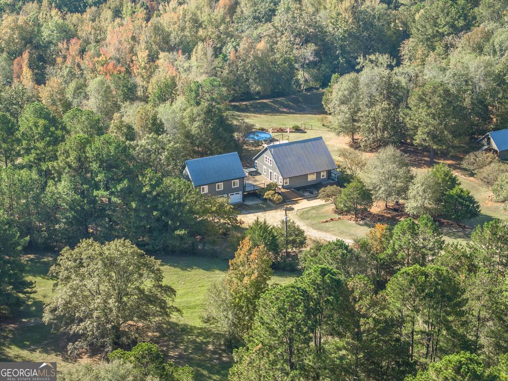 an aerial view of a house with a yard