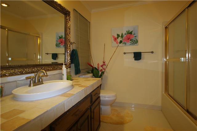 318 Stoneybrook Road Columbia, TN 38401 - Photo 14 of 20 Upstairs full bath with raised tile vanity, shower/tub combo, tile floor, and linen closet.