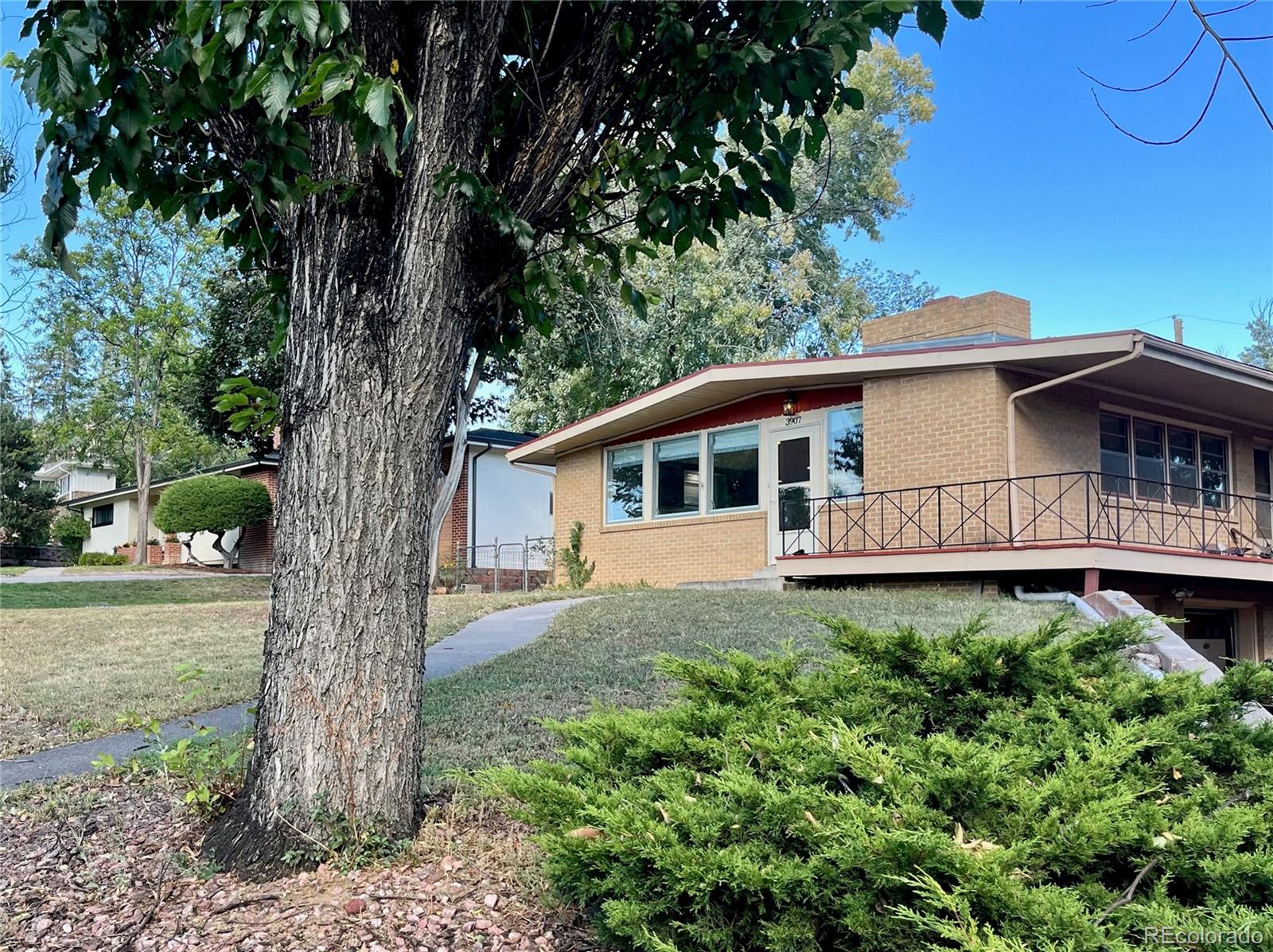 a house with lots of trees in the background