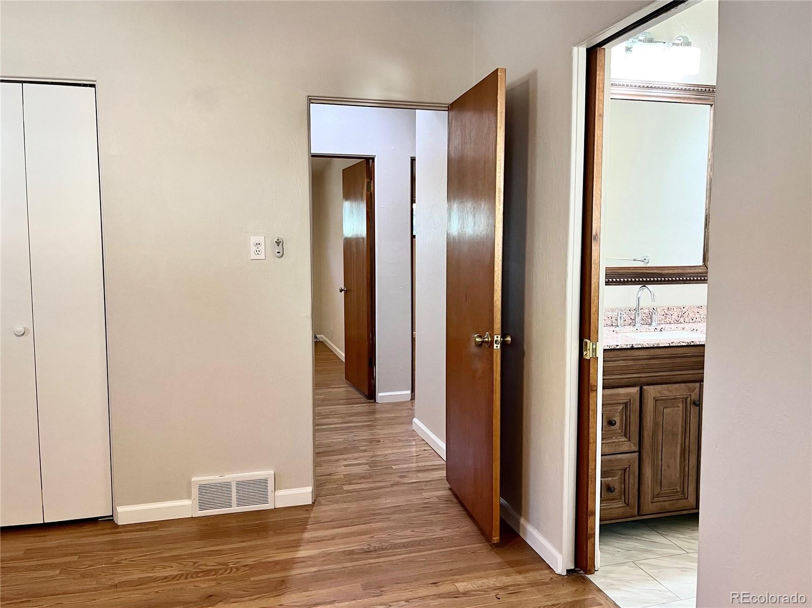 3907 Jasmine Street Colorado Springs, CO 80907 - Photo 11 of 23 a view of a hallway with wooden floor and closet area