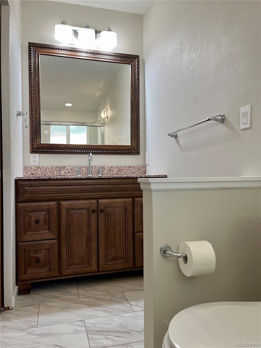 3907 Jasmine Street Colorado Springs, CO 80907 - Photo 13 of 23 a bathroom with a sink and a mirror