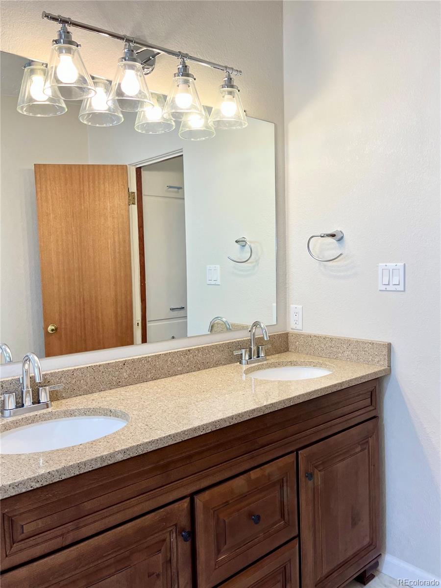 3907 Jasmine Street Colorado Springs, CO 80907 - Photo 16 of 23 a bathroom with a sink and a mirror
