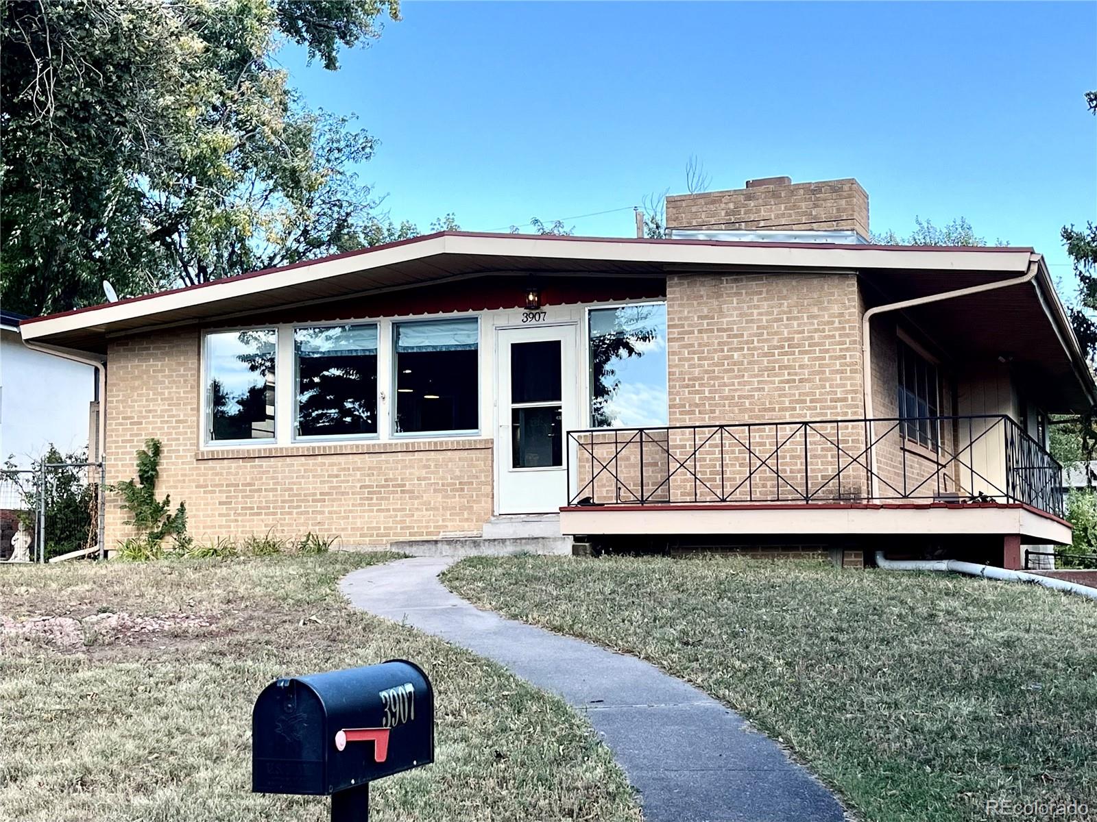3907 Jasmine Street Colorado Springs, CO 80907 - Photo 2 of 23 a view of a house with a backyard