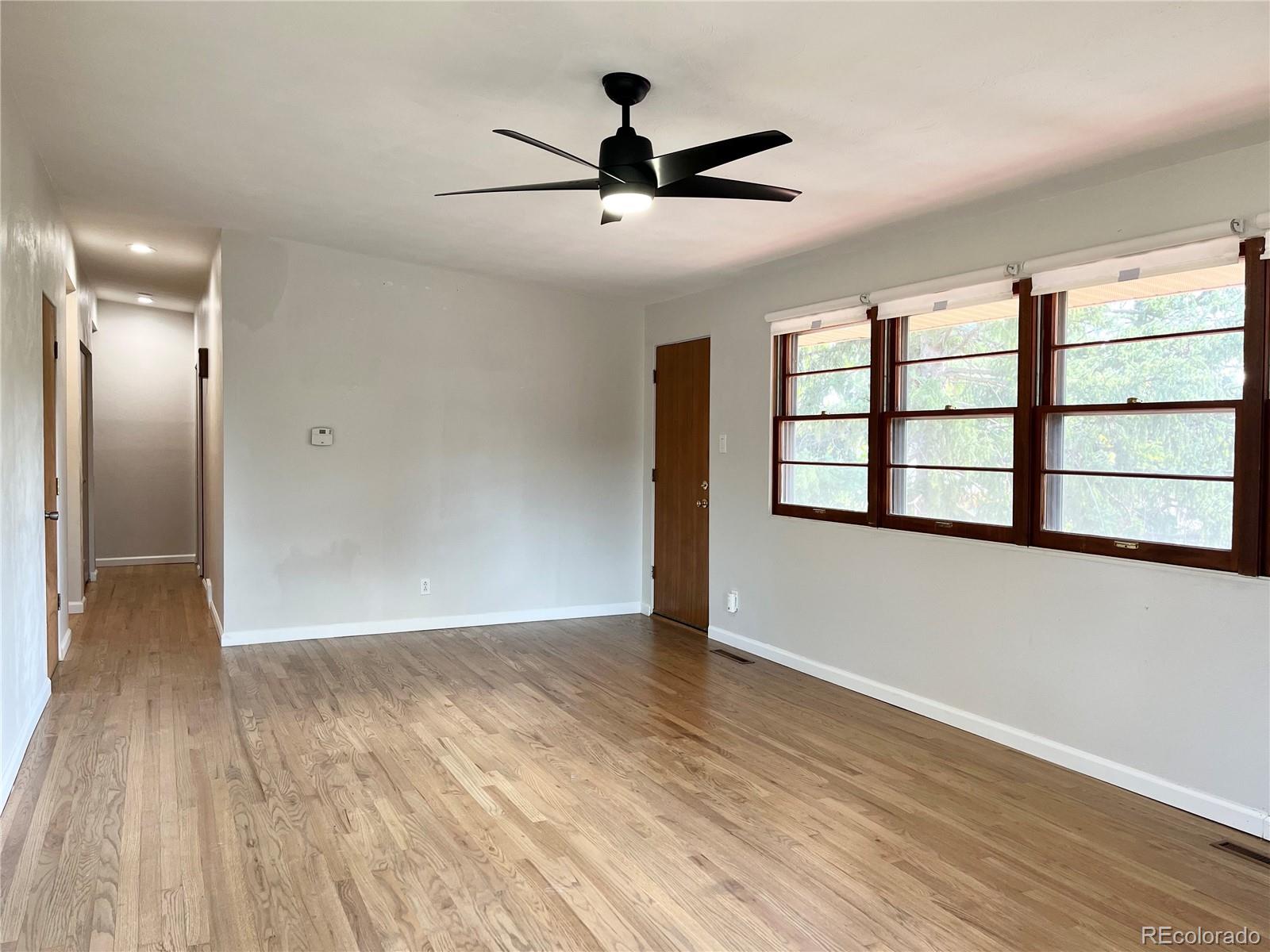 3907 Jasmine Street Colorado Springs, CO 80907 - Photo 5 of 23 a view of empty room with wooden floor and fan