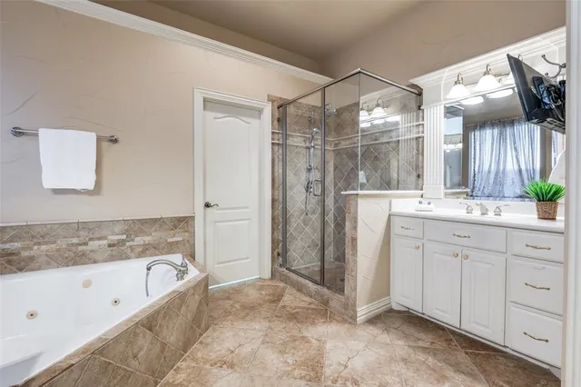 a bathroom with a granite countertop sink mirror and a bathtub
