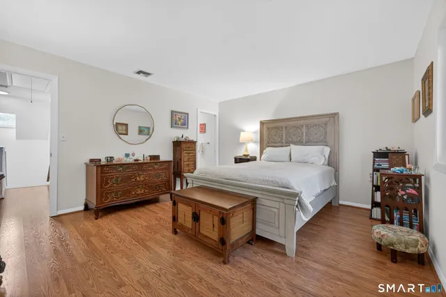 a bedroom with a bed and a dresser