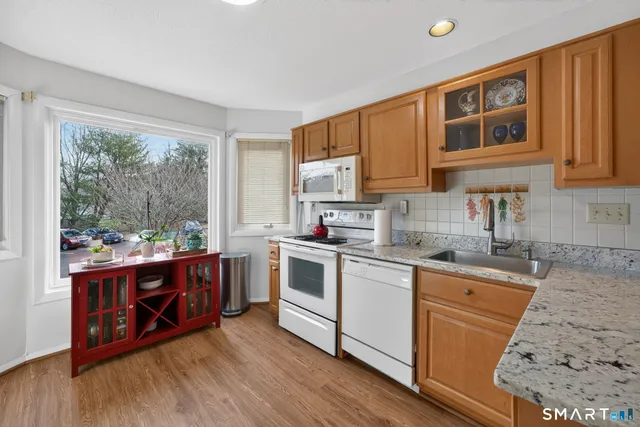 a kitchen with stainless steel appliances granite countertop a stove and a sink