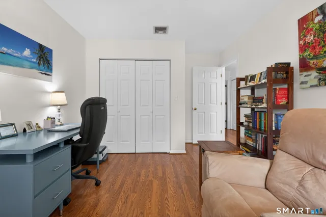 a view of a workspace with furniture and a workspace