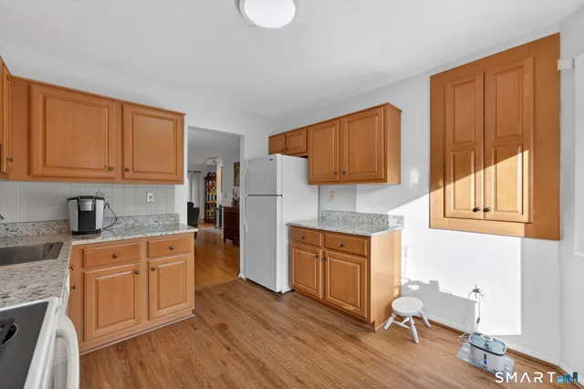 a kitchen with stainless steel appliances granite countertop a stove a sink dishwasher and a microwave oven with cabinets