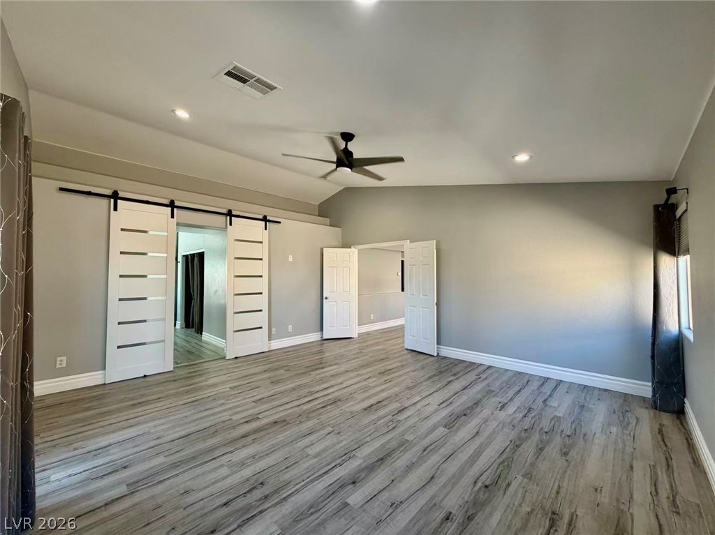 135 Tall Ruff Drive Las Vegas, NV 89148 - Photo 16 of 29 The generously sized living area offers elegant wood flooring and a modern ceiling fan for year-round comfort.