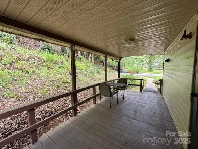 a view of a porch with furniture and wooden floor