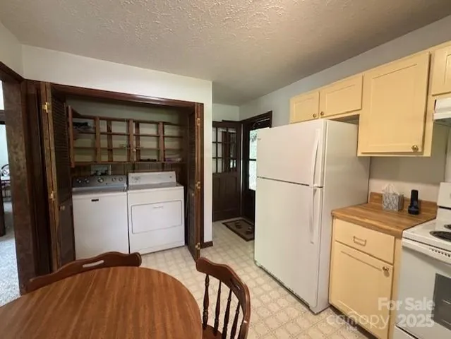 a kitchen with a refrigerator and cabinets