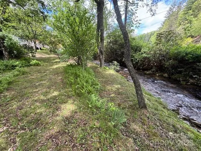 a backyard of a house with a yard and outdoor seating