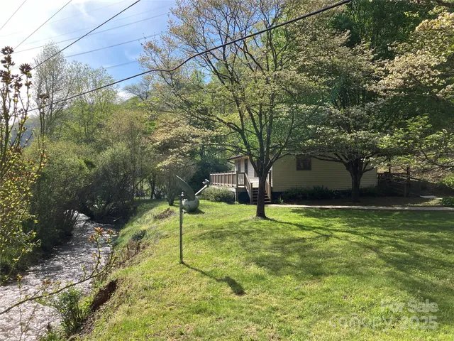 a yellow house in middle of the forest