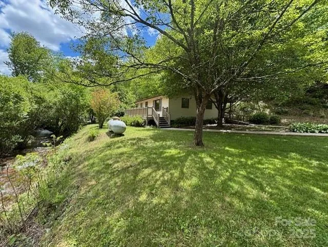 a backyard of a house with lots of green space