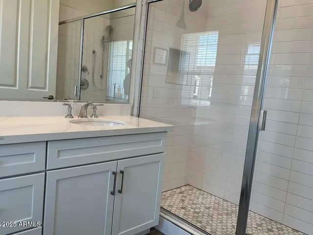 a bathroom with a sink a toilet and a window